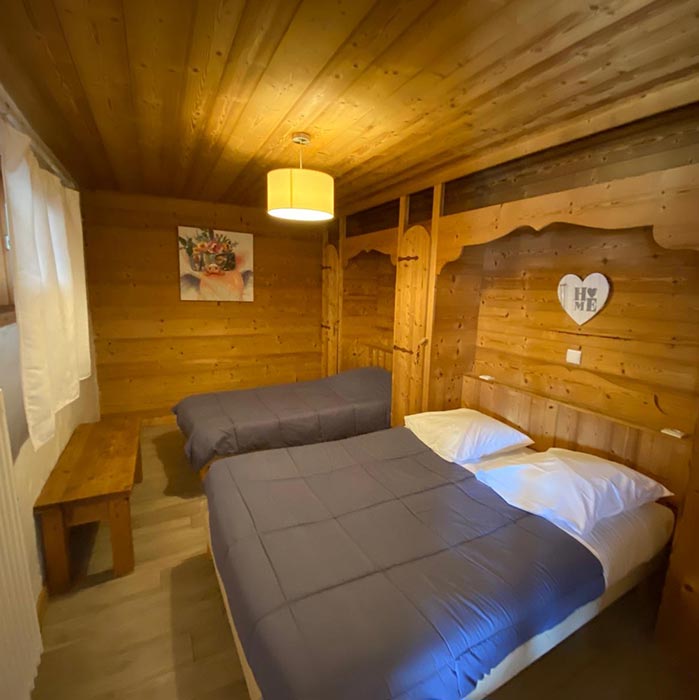 chambre avec un lit simple et un lit double